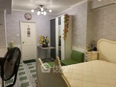 Charming bedroom with elegant decor and cozy ambiance, featuring stylish furniture and unique flooring.
