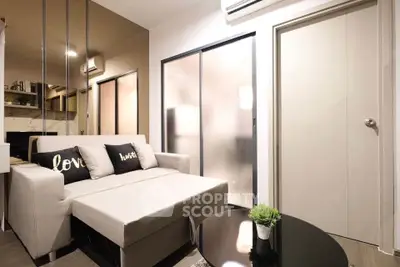 Modern living room with stylish sofa and chic decor in cozy apartment.