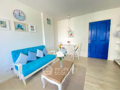 Charming living room with vibrant blue accents and cozy dining area, perfect for modern living.