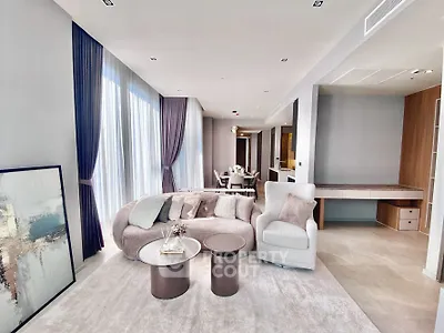Luxurious modern living room with elegant decor and abundant natural light