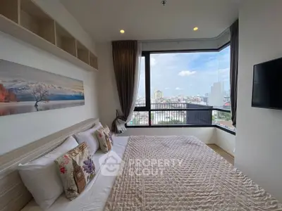 Spacious bedroom with panoramic city view and modern decor