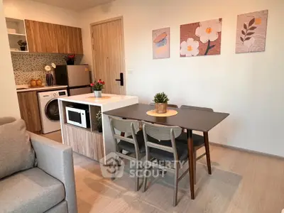 Modern open-plan kitchen and dining area with stylish decor and appliances.