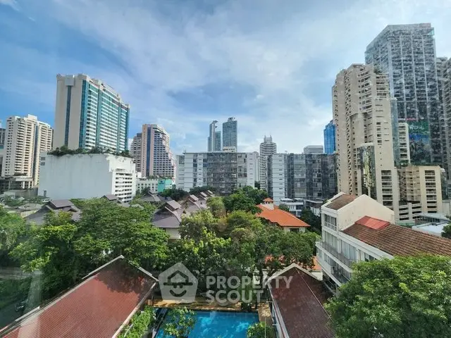 Stunning cityscape view with high-rise buildings and lush greenery, showcasing urban living at its finest.