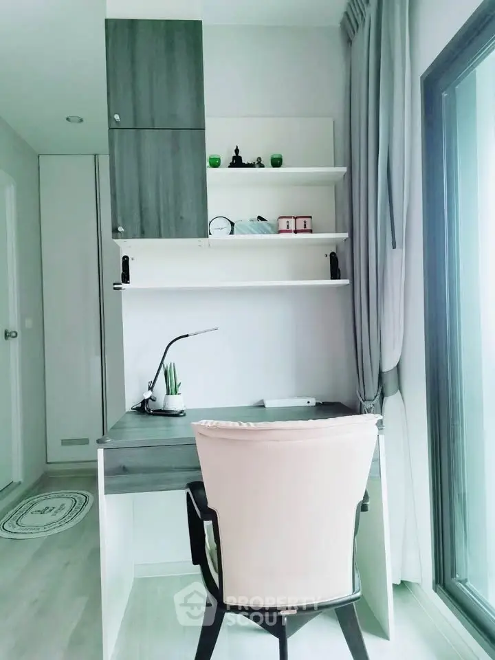 Modern study room with sleek desk and large window for natural light