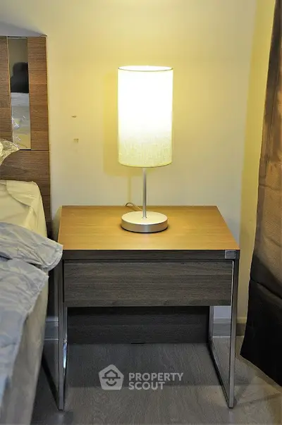 Modern bedroom nightstand with lamp, perfect for cozy ambiance.
