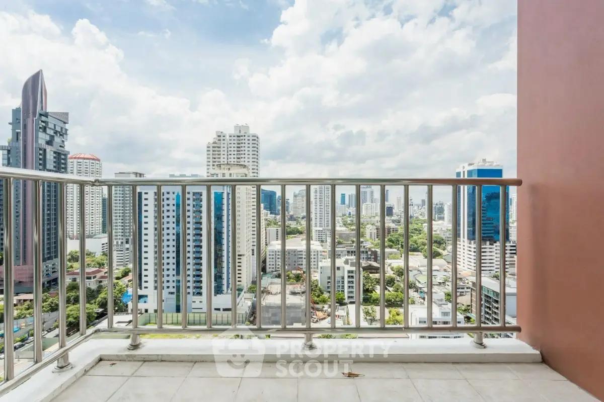 Stunning cityscape view from a high-rise balcony with sleek railing.