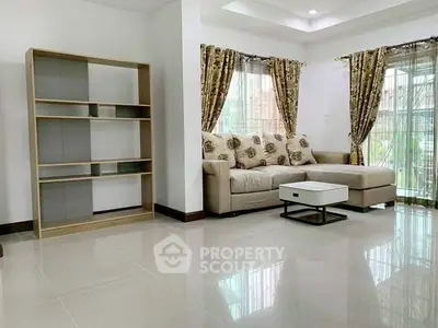 Spacious living room with modern sofa and elegant curtains, perfect for relaxation and entertaining.