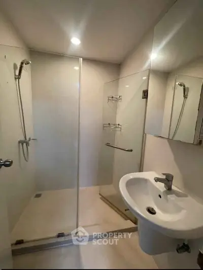 Modern bathroom with glass shower enclosure and sleek fixtures