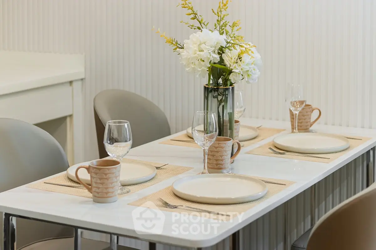 Elegant dining area with modern table setting and floral centerpiece