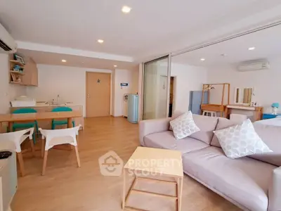 Spacious open-plan living room with modern furniture and dining area.