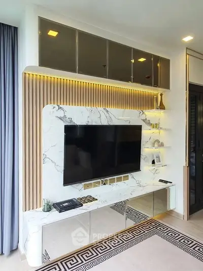 Luxurious modern living room with elegant marble TV wall and stylish shelving.