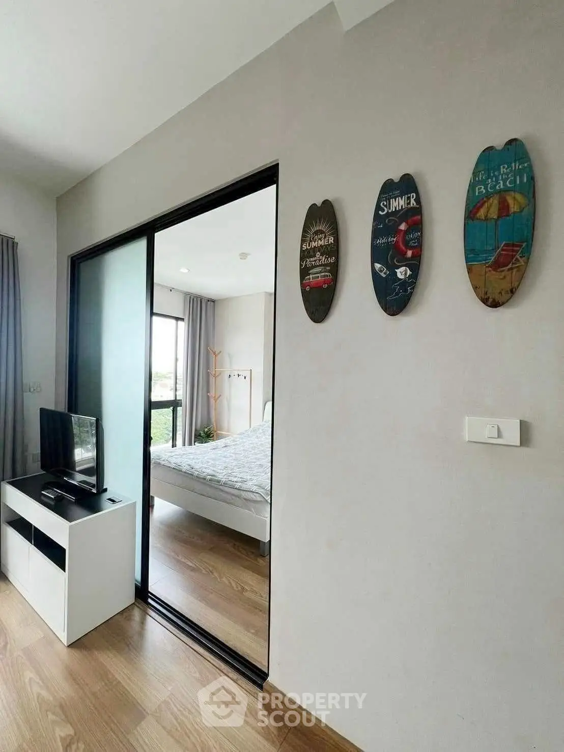 Modern bedroom with sliding glass door and stylish decor in a cozy apartment.