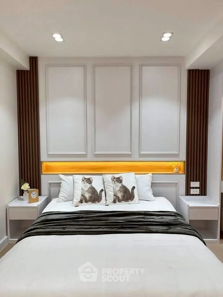 Modern bedroom with stylish decor and cozy lighting, featuring a comfortable bed and elegant wall panels.