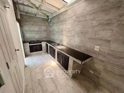 Modern kitchen with sleek countertops and gas stove in a stylish home.