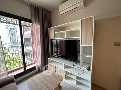 Modern living room with balcony view and sleek TV unit in urban apartment