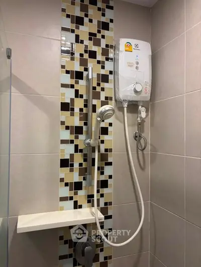 Modern bathroom shower with stylish tile design and water heater installation.