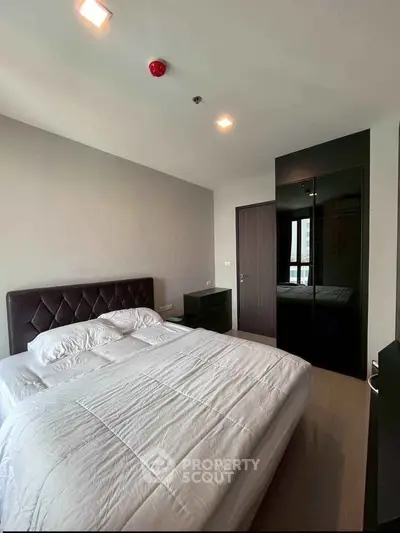 Modern bedroom with sleek design and ample natural light