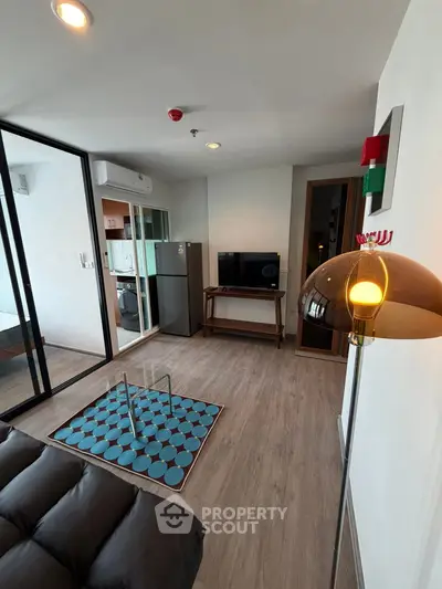 Modern living room with stylish decor and balcony access in a contemporary apartment.