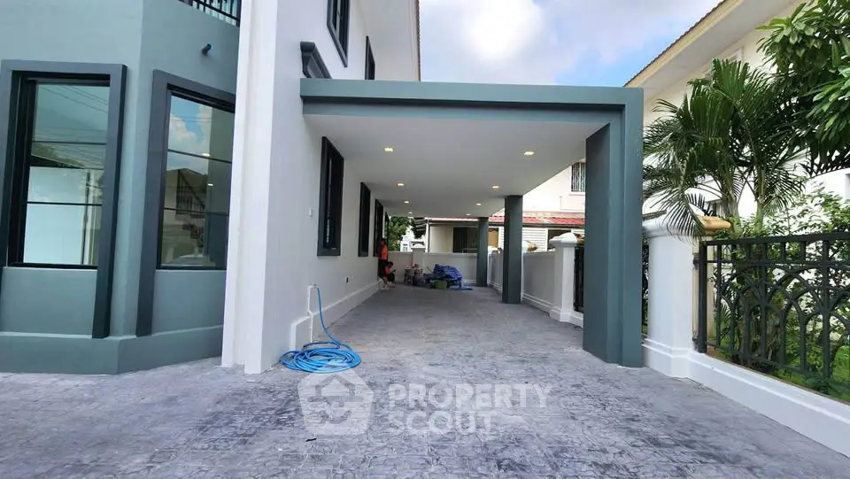 Modern home exterior with spacious driveway and sleek architectural design.