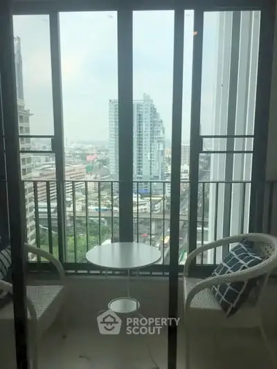 Chic urban balcony with city view, perfect for relaxation and enjoying the skyline.