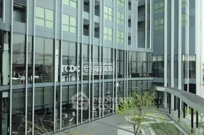 Modern building exterior with large glass windows and sleek architectural design.