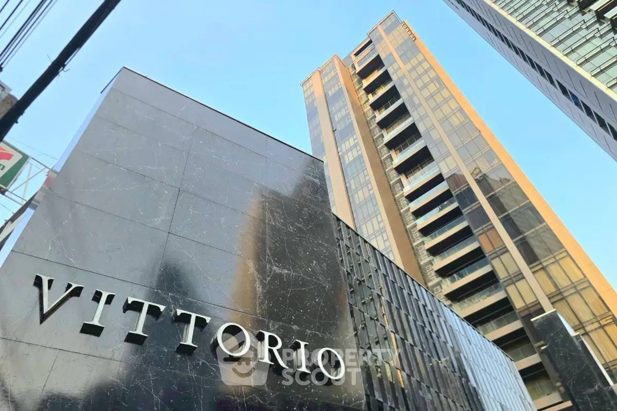 Modern high-rise building with sleek exterior and prominent Vittorio signage.