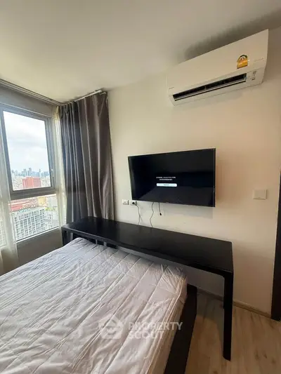 Modern bedroom with city view, featuring sleek furniture and wall-mounted TV, ideal for urban living.