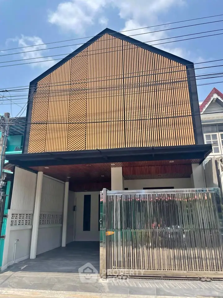 Modern urban house with sleek facade and gated entrance
