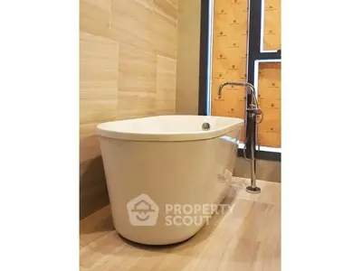 Luxurious bathroom with elegant freestanding bathtub and modern fixtures.