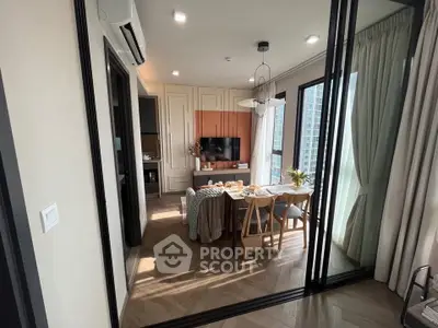 Modern living room with stylish dining area and large windows in a high-rise apartment.