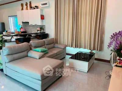 Spacious modern living room with elegant decor and open kitchen layout, perfect for stylish urban living.