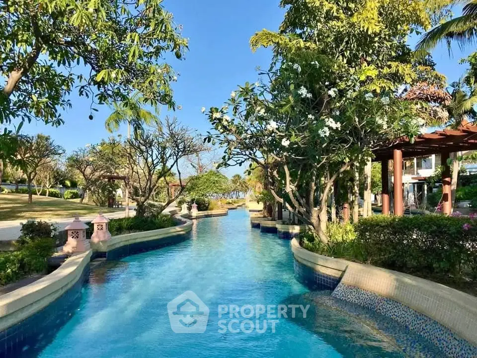 Luxurious resort-style pool with lush greenery and serene ambiance