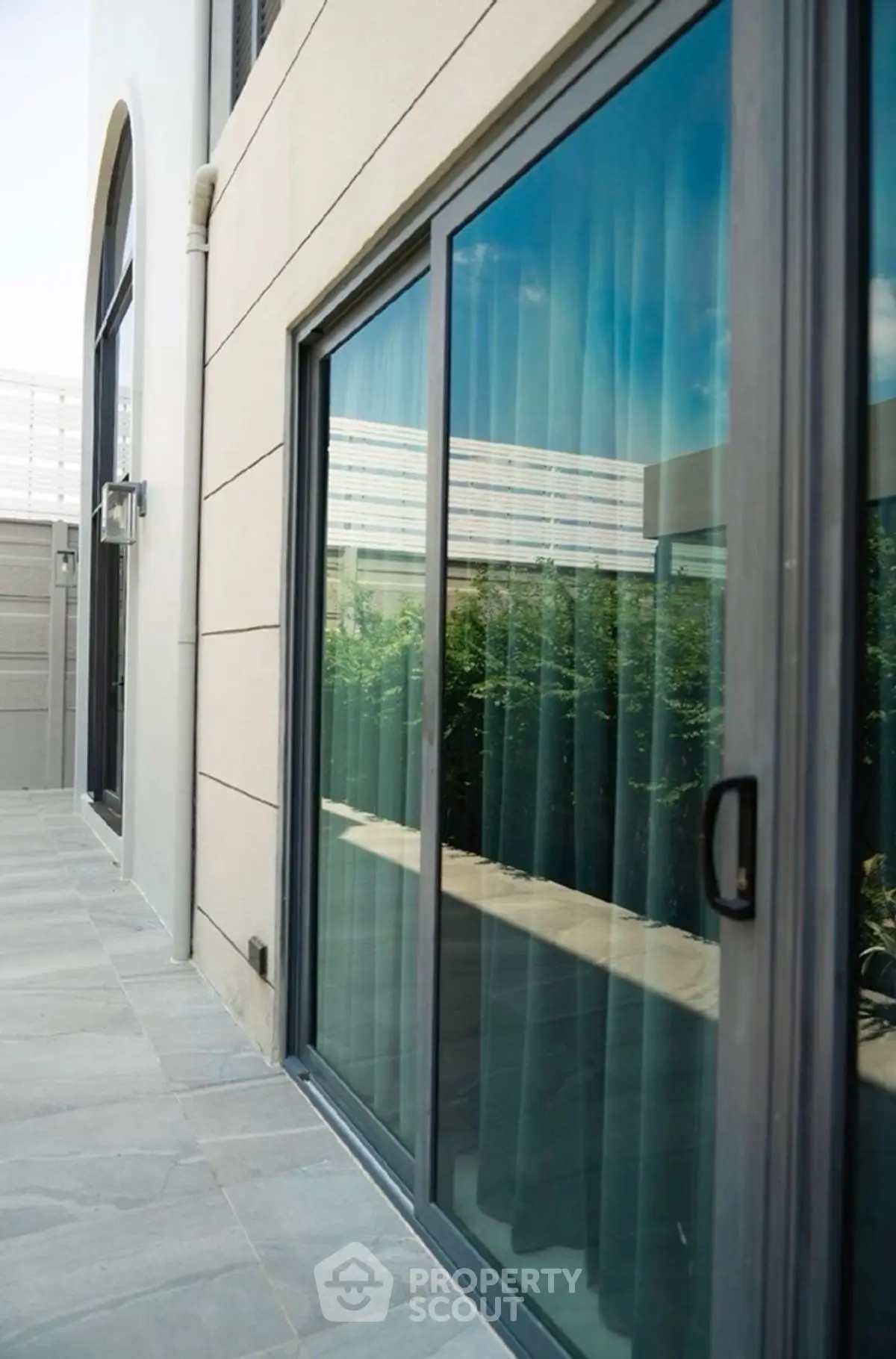 Modern exterior with sliding glass doors and sleek design