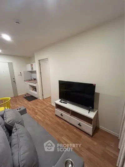 Modern living room with sleek TV stand and cozy gray sofa