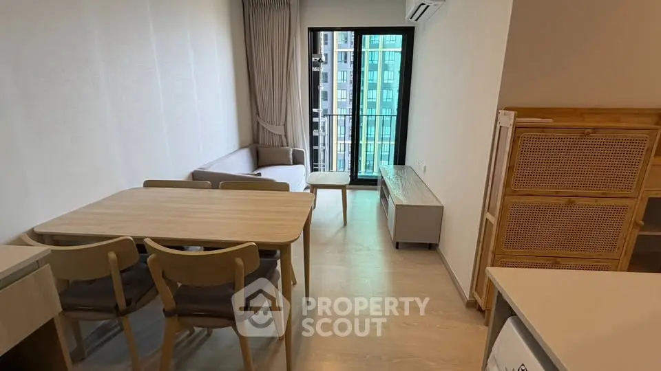 Modern living room with stylish furniture and balcony view in a contemporary apartment.