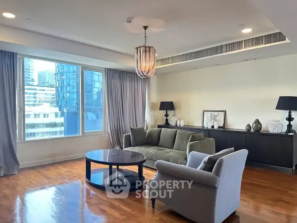 Spacious living room with modern furniture and large window view