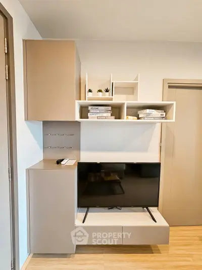Modern living room with sleek TV unit and stylish shelving, perfect for contemporary urban living.