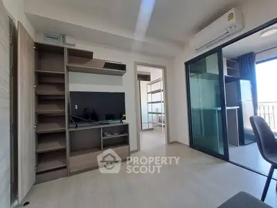 Modern living room with built-in shelves and air conditioning in a bright apartment.