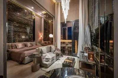 Luxurious modern bedroom with elegant decor and stunning city view balcony.
