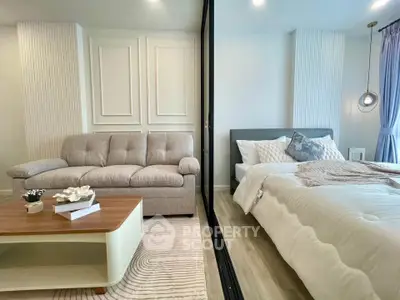 Modern bedroom with cozy sofa and stylish decor in a bright, elegant apartment.