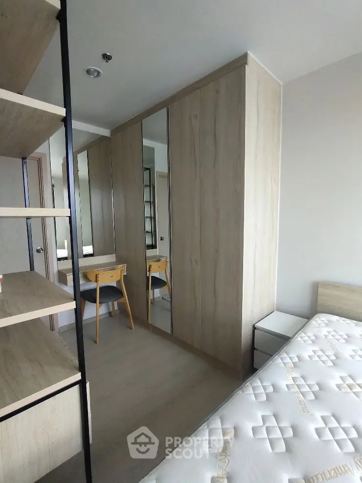 Modern bedroom with built-in wardrobe and cozy workspace