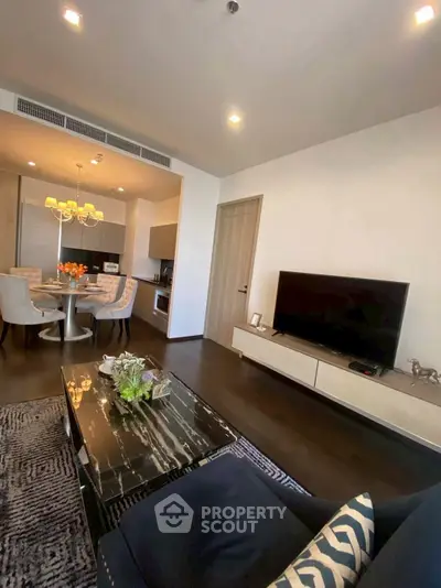 Modern living room with sleek furniture and open kitchen layout