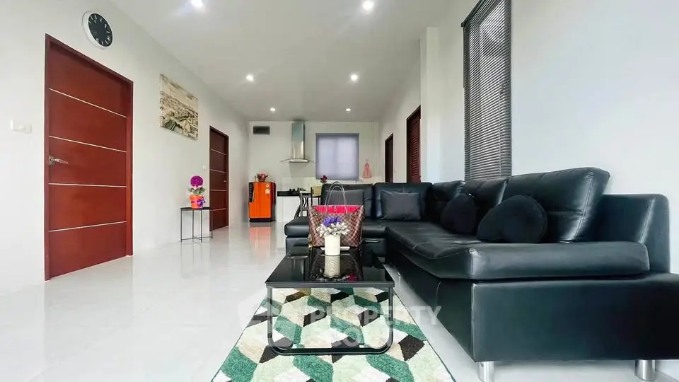 Modern living room with sleek black sofa and stylish decor