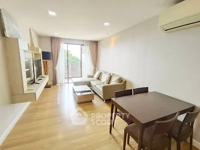 Spacious living room with modern furniture and balcony view