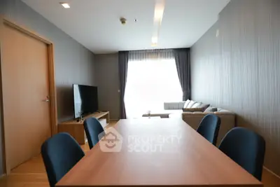 Modern living room with dining area and stylish furniture in a cozy apartment.