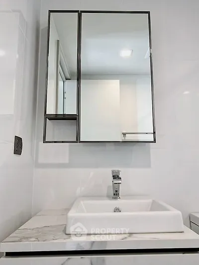 Modern bathroom with sleek mirror cabinet and stylish sink