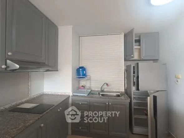 Modern kitchen with grey cabinets and granite countertops