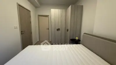 Cozy bedroom with modern wardrobe and comfortable bed in a stylish apartment.