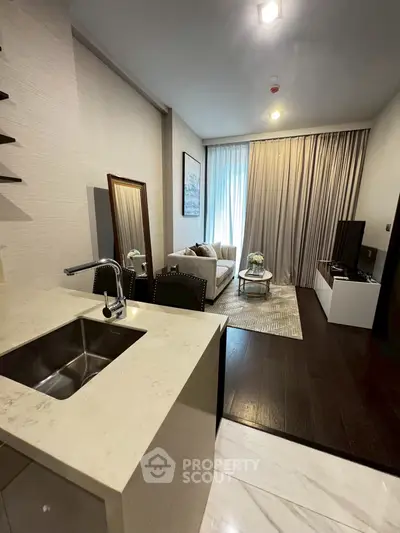 Modern open-plan living room with elegant decor and kitchen island