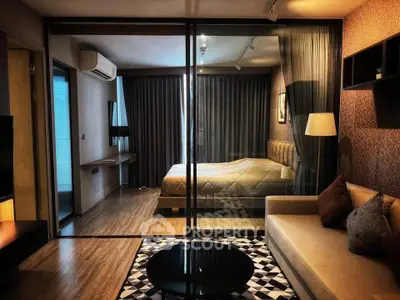 Luxurious modern bedroom with glass partition and cozy living area, perfect for urban living.